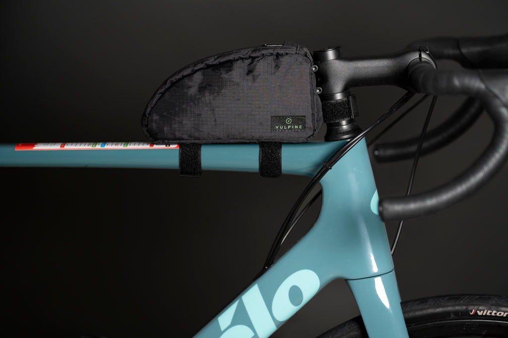 Black Vulpine Finnieston Top Tube Bag mounted on a teal road bike frame